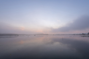 Morning nature scene, sky, clouds and fog (mist) on the lake