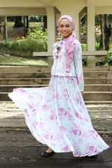 Fototapeta premium One Malay woman wearing headscarf looking watching walking dancing smiling