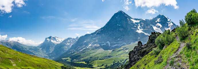 Naklejka na ściany i meble Switzerland, Panoramic view on Eiger, Monch and Yungfrau and green Alps around Mannlichen