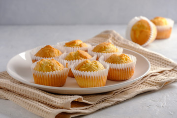 Delicate and delicious lemon cupcakes with crisp on a white plate