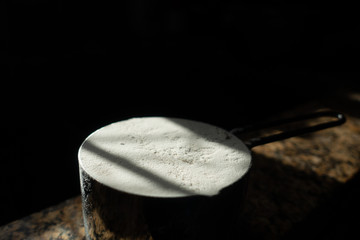 Metal 1-Cup measurement of flour with leveled top
