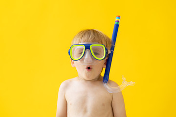 Portrait of funny child against yellow background