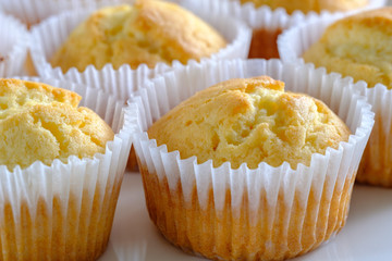 Delicate and delicious lemon cupcakes with crisp on a white plate