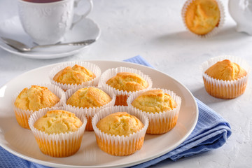 Delicate and delicious lemon cupcakes with crisp on a white plate