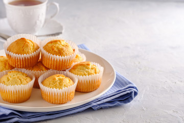 Delicate and delicious lemon cupcakes with crisp on a white plate