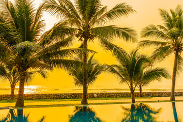 Beautiful nature with palm tree around sea ocean beach at sunset or sunrise