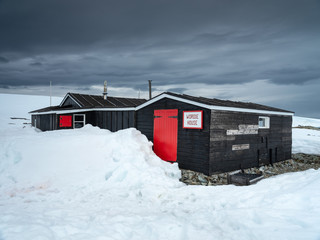old warehouse of old english polar station in snow in Antarctica
