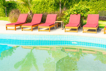 Beautiful empty chair around outdoor swimming pool in hotel resort