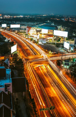 Fototapeta na wymiar CHIANG MAI, THAILAND - FEBRUARY 20, 2020 : Top view with wide angle of The car light trails in the cityscape at night scene in Chiang Mai, Thailand..