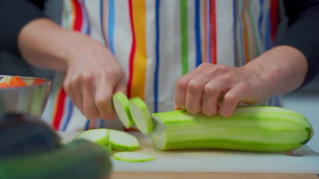 Chef's hands cutting vegetables into pieces
