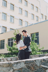 Fototapeta na wymiar Couple Dating Enjoyment Hugging Urban City Concept. Valentine's Day celebration. Young beautiful couple in love dating outdoors and smiling