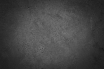 Fototapeta premium Dark concrete textured wall background.black grunge cement wall texture for interior design. dark edges.copy space for add text.
