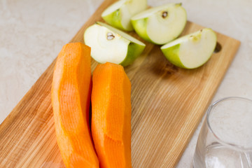 detox. smoothies. the process of making juice in the kitchen. A glass of fresh carrot juice. carrot and Apple on the table. detoxification, vegetarian diet. juicy healthy vitamin drink. juicer.