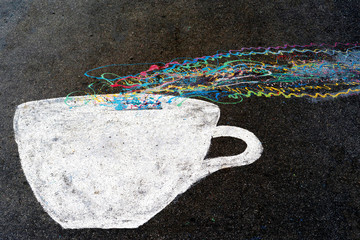 A Cup of coffee or tea with smoke painted on the asphalt, in the city