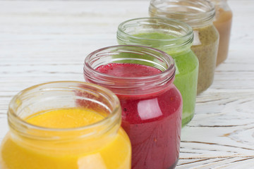 Assortment of jars with tasty baby food on wooden table. vegetable and fruit purees.