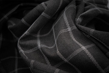Black silk background. Material.