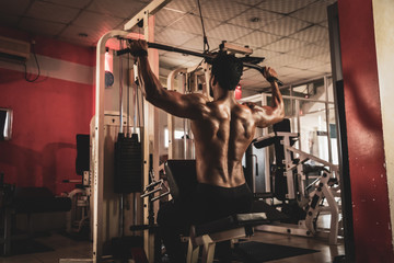 Fitness man working out lat pulldown training at gym