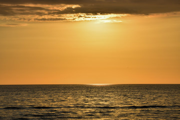 Reflection of the sun at sunrise at sea.