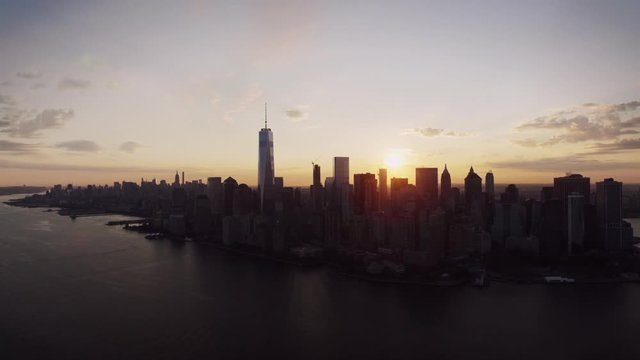 New York City modern popular skyline cityscape in warm evening orange sunset in beautiful drone aerial panorama flyover