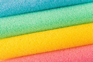 Foam colored curlers on a light background. Abstract background. Selective focus.