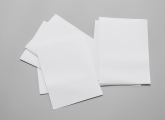Poster mock-ups paper, white paper isolated on gray background, Blank portrait paper A4. brochure magazine , can use banners products business texture background for your. newspaper