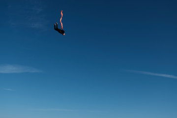 Skydiving. A skydiver with a tube in the blue sky.