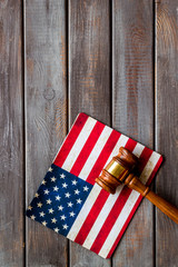 Fototapeta na wymiar Law and justice in USA concept. Judge gavel near american flag on dark wooden background top-down copy space