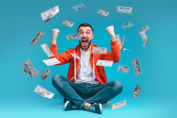Young attractive bearded man celebrating victory after betting at bookmaker's website