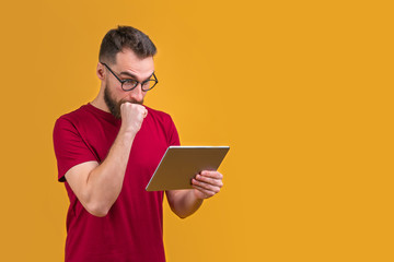 Young attractive bearded man betting at bookmaker's website
