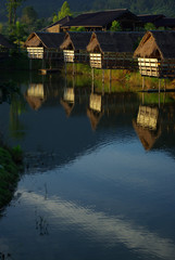 Fototapeta premium In the morning light small huts beside the lake and the mountain view