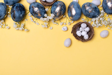Flat Lay of Golden Easter Eggs in row placed on yellow background. Easter background or easter concept.