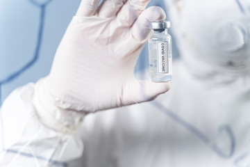 Focused photo on male hand that demonstrating vaccine