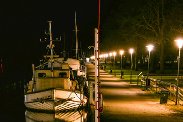 Fototapeta na wymiar Norrtalje, Sweden Boats at night along the Norrtalje canal.