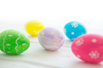 Fototapeta na wymiar Easter eggs on a white wooden surface