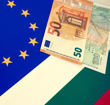 Bulgarian and European Union banknotes in front of EU and Bulgarian flag
