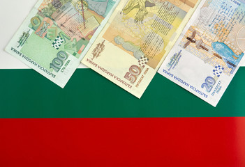 Bulgarian banknotes in front of  Bulgarian flag
