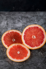 Sliced juicy fresh grapefruit on a marble. top view
