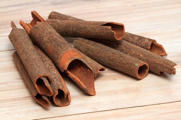 Cinnamon,  Cinnamomum cassia called Chinese cassia.  Also Chinese cinnamon, sticks on the wooden table