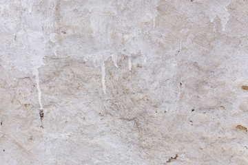 Background of old damaged adobe house with cracked plaster. Grungy texture of old weathered stucco wall. Retro aged surface. Antique and textured backdrop. Rough shabby structure, textured pattern