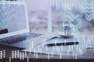Forex graph hologram on table with computer background. Double exposure. Concept of financial...