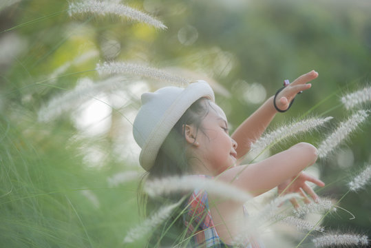 traveler or tourism. happy little asian girl child in flower fields  with big smile and laughing healthy happy funny smiling face young adorable lovely female kid.  happy lifestyle concept.