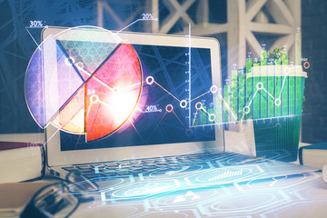 Double exposure of chart and financial info and work space with computer background. Concept of international online trading.