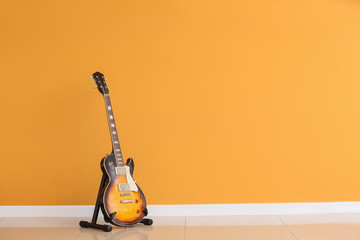 Modern guitar near color wall