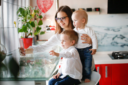 Mother With Two Children Talking Video Laptop