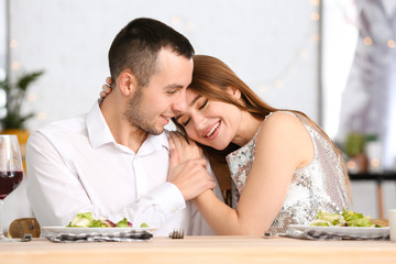 Happy young couple on romantic date in cafe