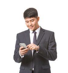 Young Asian businessman with mobile phone on white background
