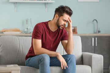 Portrait of worried young man at home