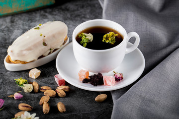 Obraz na płótnie Canvas Jasmin tea with lokum , milky dessert and pistachios