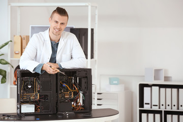 Portrait of electronic technician in service center
