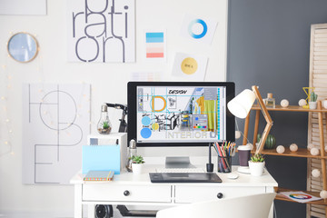Comfortable workplace of interior designer in office - obrazy, fototapety, plakaty